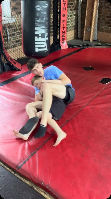 A junior student working from back control during a grappling drill.